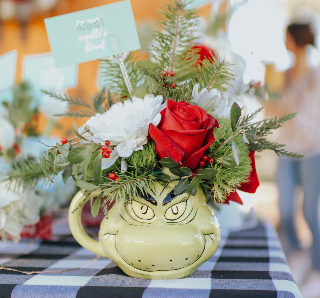 grinch coffee mug filled with flowers