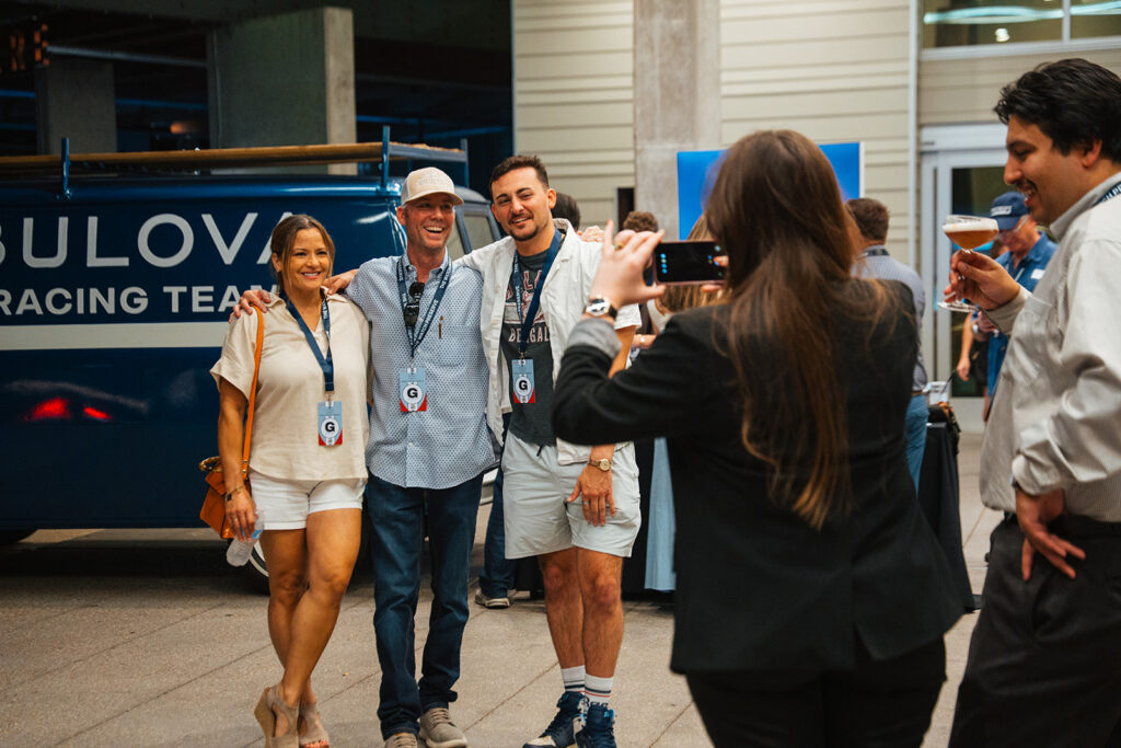 Wheels | Watches | Whiskey 2026 in Bryan Texas draws crowd. Group poses in front of the Bulova Racing Team van for a picture in front of The Stella Hotel.